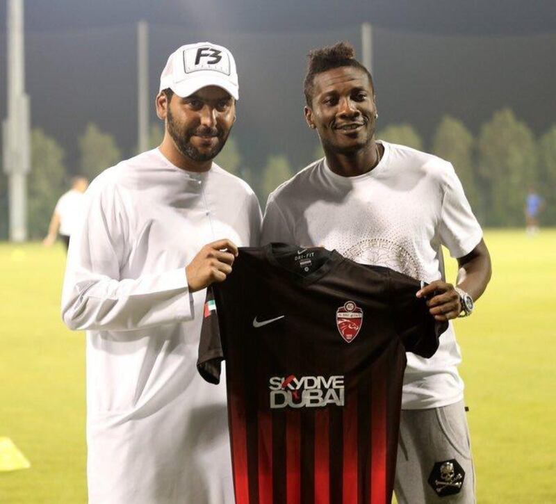 Asamoah Gyan, right, alongside Al Ahli chairman Abdullah Al Naboodah. Courtesy Al Ahli FC