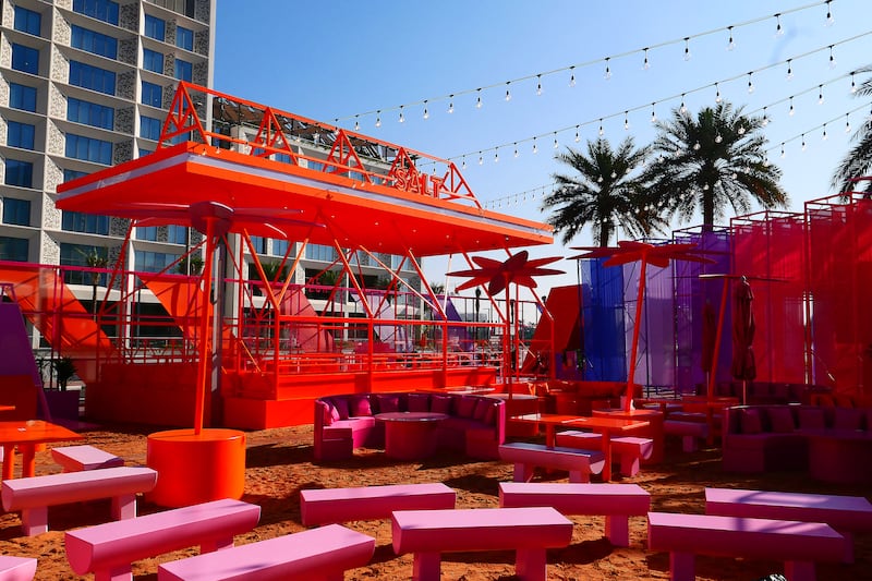Benches are set on a pop-up beach, where guests can enjoy live entertainment as well as Salt's signature burgers.