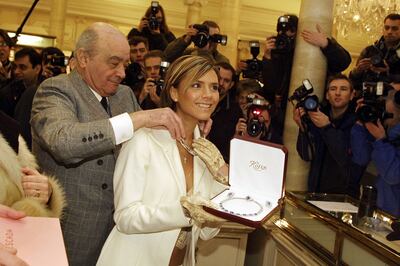 Former Spice Girl Victoria Beckham and Mohamed Al Fayed show off the most expensive item in the Harrods winter sale in 2002. Getty Images