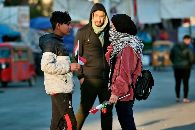 Protesters hold Valentine's Day gifts in during anti-government protests in Baghdad. AP Photo