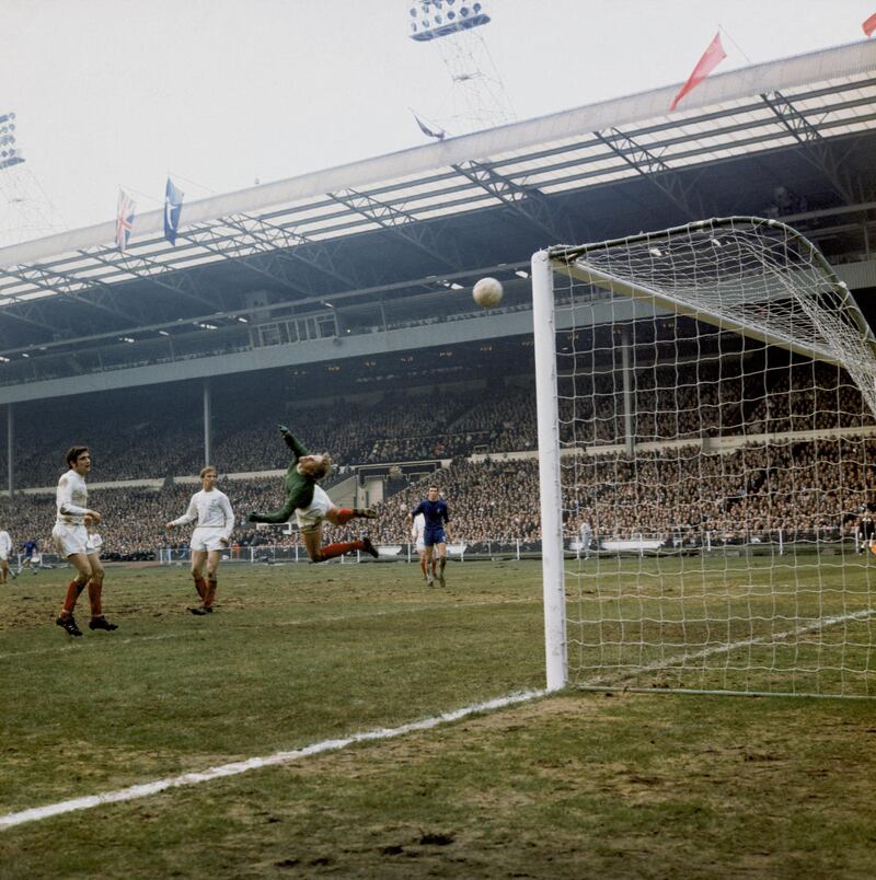 Leeds United defenders Norman Hunter (left) and Jack Charlton (centre) watch as a shot goes over Leeds goalkeeper Gary Sprake during their FA Cup Final appearance against Chelsea FC at Wembley Stadium, London, 11th April 1970. The match ended in a 2-2 draw and the final was replayed at Old Trafford, where Chelsea won 2-1.  (Photo by Daily Express/Hulton Archive/Getty Images)