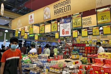 A shopper, wearing a protective mask, looks at shelves at a Nesto supermarket in Ajman during the Covid-19 outbreak. The National