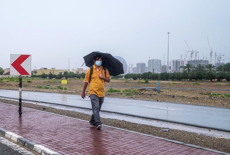 Abu Dhabi, United Arab Emirates, April 15, 2020.  A pedestrian walks in the rain at Khalifa City, Abu Dhabi.
Victor Besa / The National
Section:  NA
For:  Standalone/Stock Images