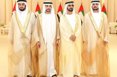 This handout picture provided by the UAE Ministry of Presidential Affairs on June 6, 2019 shows, Ruler of Dubai Sheikh Mohammed bin Rashid Al-Maktoum (2nd R), posing for a photograph with his sons, Crown Prince Sheikh Hamdan bin Mohammed (2nd L), Sheikh Maktoum bin Mohammed, (R), and Sheikh Ahmed bin Mohammed, on their wedding day in Dubai. (Photo by - / UAE Ministry of Presidential Affairs / AFP) / XGTY / RESTRICTED TO EDITORIAL USE - MANDATORY CREDIT "AFP PHOTO / UAE MINISTRY OF PRESIDENTIAL AFFAIRS - NO ADVERTISING CAMPAIGNS - DISTRIBUTED AS A SERVICE TO CLIENTS