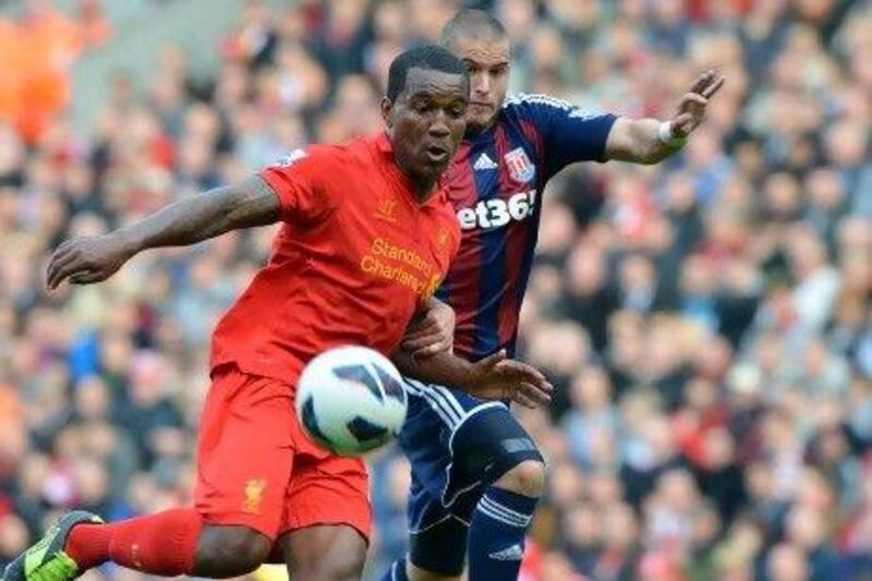 The progress Andre Wisdom, left, has made at Liverpool has brought him international recognition. Paul Ellis / AFP