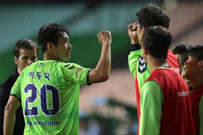 Lee Dong-Gook celebrates with teammates after scoring. Getty Images