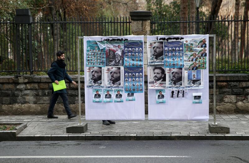 A man walk near parliamentary election campaign posters in Tehran, Iran February 20, 2020. WANA (West Asia News Agency)/Nazanin Tabatabaee via REUTERS ATTENTION EDITORS - THIS IMAGE HAS BEEN SUPPLIED BY A THIRD PARTY.