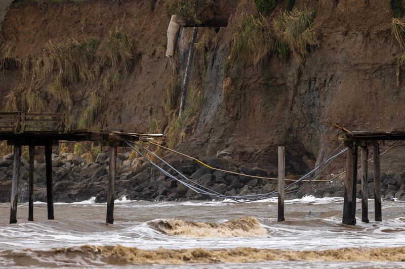 An eroding sea cliff behind the wharf in Capitola. AFP