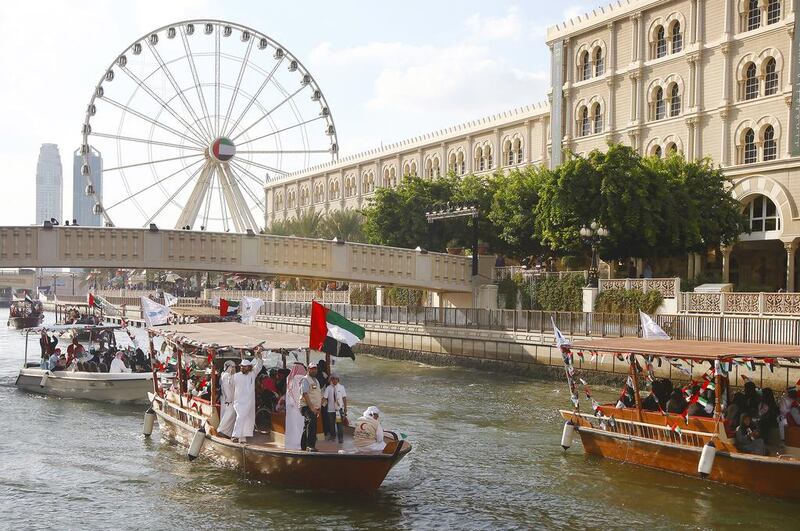 The sea parade enters the Qasba canal, in celebration of the 43rd UAE National Day, in Sharjah. Jeffrey E Biteng / The National