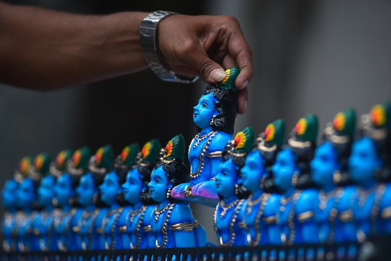 A vendor arranges idols of Krishna in Chennai. EPA