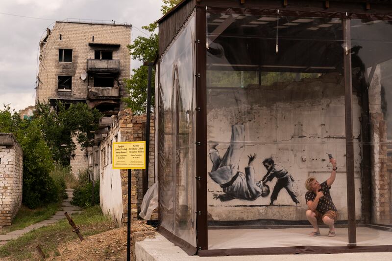 A Banksy artwork on the wall of a building damaged by Russian attacks in Borodyanka, Ukraine. AP
