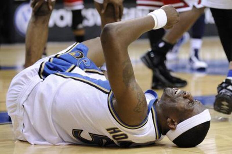 Josh Howard of the Wizards writhes in pain after injuring his left knee against the Bulls.