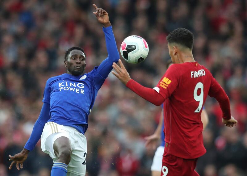 Leicester City's Wilfred Ndidi vies for the ball with Firmino. Associated Press