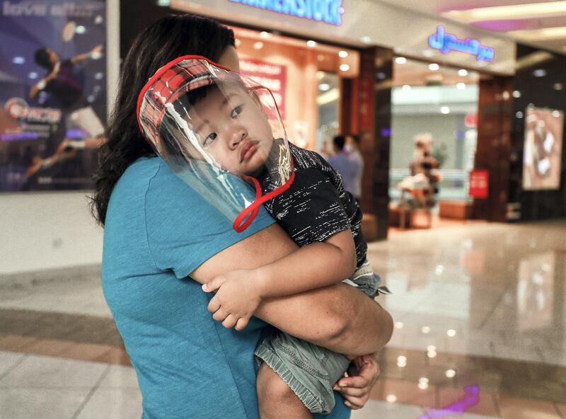 Abu Dhabi, United Arab Emirates, August 23, 2020.   
Aris-2 goes around with his aunt with a face sheild on in Al Wahda Mall, Abu Dhabi.
Victor Besa /The National
Section:  NA
Reporter: