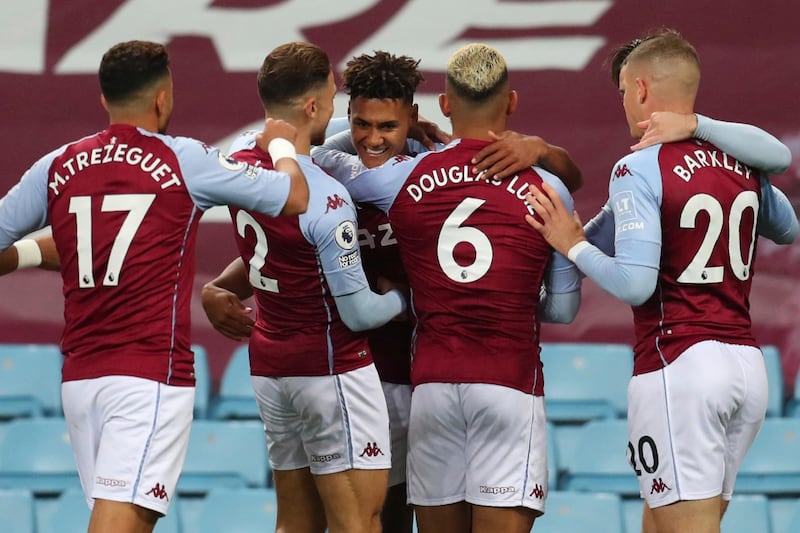 Aston Villa's Ollie Watkins, center, celebrates with his teammates after scoring his side's opening goal. AP