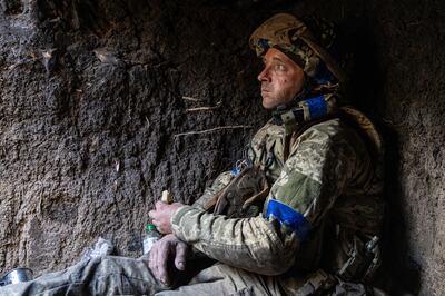 A Ukrainian serviceman eats bread in a trench at the frontline a few kilometers from Andriivka. AP