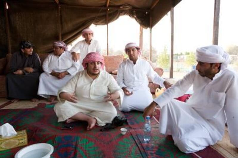 (back left) Ahmad Saleh Alshehhi, Abdullh Alkhomer, Sultan Alshehhi. (front left) Mohammed Boshowairb, Mohammed Alshehhi and Jassm Alkhomere. True to reality and far removed from the tourist farms a group of emiratis attempt to represent their culture as the see it. Entertaining  tourists to both explain their traditional culture and how they live today. Duncan Chard for the National. Taken April 21, 2011
