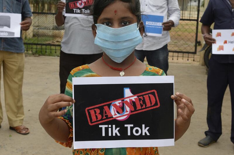 Members of the City Youth Organisation hold posters with the logos of Chinese apps in support of the Indian government for banning the wildly popular video-sharing 'Tik Tok' app, in Hyderabad on June 30, 2020. - TikTok on June 30 denied sharing information on Indian users with the Chinese government, after New Delhi banned the wildly popular app citing national security and privacy concerns.
"TikTok continues to comply with all data privacy and security requirements under Indian law and have not shared any information of our users in India with any foreign government, including the Chinese Government," said the company, which is owned by China's ByteDance. (Photo by NOAH SEELAM / AFP)