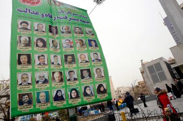 Iranians walk past an electoral billboard in a street of Tehran, Iran, 17 February 2020. EPA