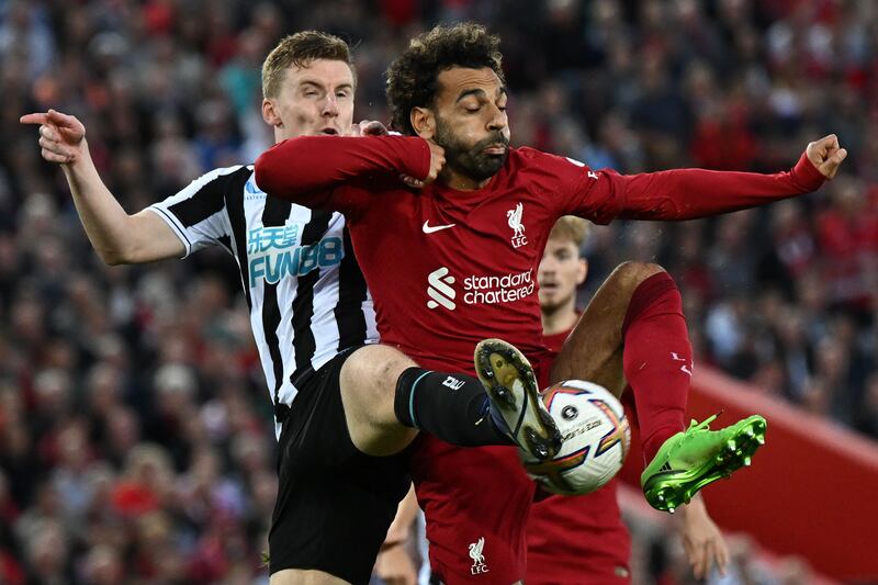 Newcastle's Matt Targett and Mohamed Salah of Liverpool battle for the ball. AFP