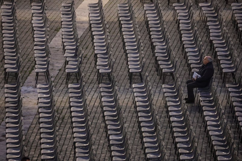 A mourner arrives early for the ceremony. EPA