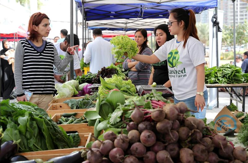 DUBAI , UNITED ARAB EMIRATES , January 18 ��� 2019 :- People buying vegetable , fruits and other organic items at the Farmers Market held at the Bay Avenue in Business Bay in Dubai. (Pawan Singh / The National ) For News/Online/Instagram. Story by Patrick
