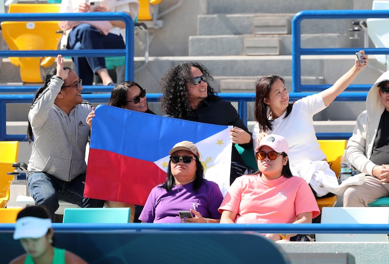 Filipino fans watch Alex Eala during her match against Magda Linette.