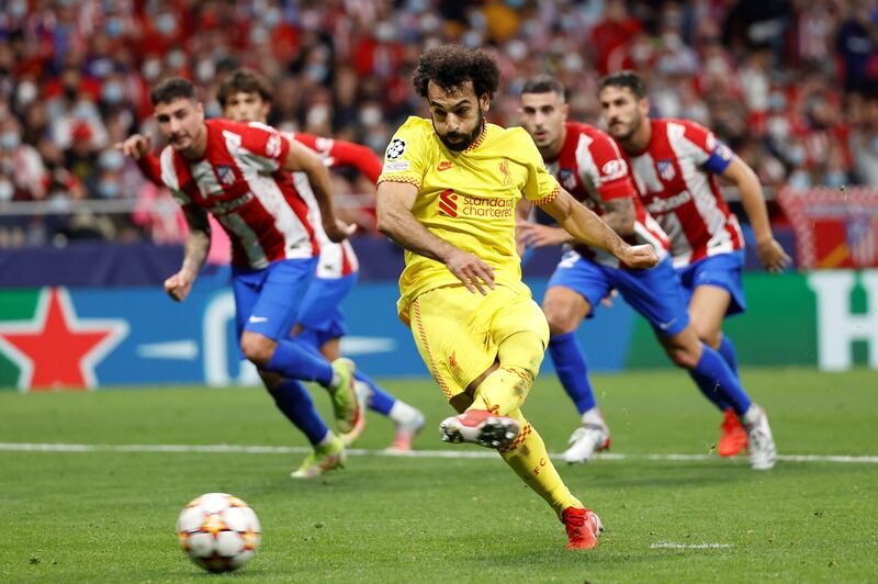 Liverpool striker Mohamed Salah scores from the spot to earn his team a 3-2 Champions League win at Atletico Madrid. EPA