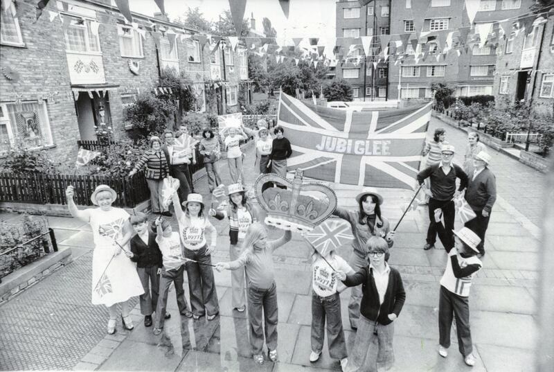 Residents in St Matthews Road, Brixton after they won a competition for the best decorated street to celebrate the Silver Jubilee of Queen Elizabeth II, south London, 10th June 1977. They have apparently coined the word 'Jubiglee', which is sewn onto their large Union Flag. (Photo by Douglas Doig/Evening Standard/Hulton Archive/Getty Images)