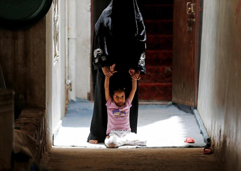 A girl is dragged by her mother to get her cholera vaccination during a house-to-house immunisation campaign in Sanaa, Yemen. Reuters