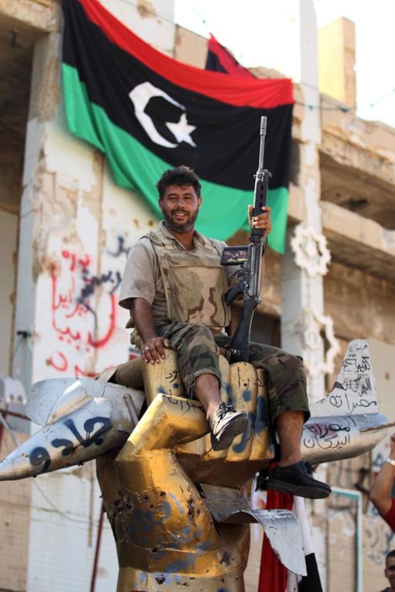 Rebel fighters delivered a knockout punch to the Qaddafi regime. Patrick Baz / AFP