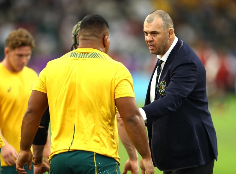 Cheika talks to players prior to the Rugby World Cup 2019 quarter-final match between England and Australia at Oita Stadium on Wednesday. Getty Images