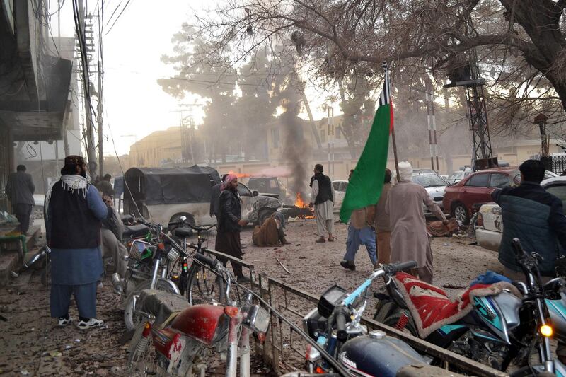 People stand amidst debris along a street following a suicide blast in Quetta on February 17, 2020.
 At least eight people -- including two police officers -- were killed and several others wounded in a suicide blast February 17 in southwestern Pakistan, officials said. The suicide attack took place in the southwestern city of Quetta in Balochistan province, which remains rife with insurgent activity, senior police official Abdul Razzaq Cheema told AFP.
 / AFP / Banaras KHAN
