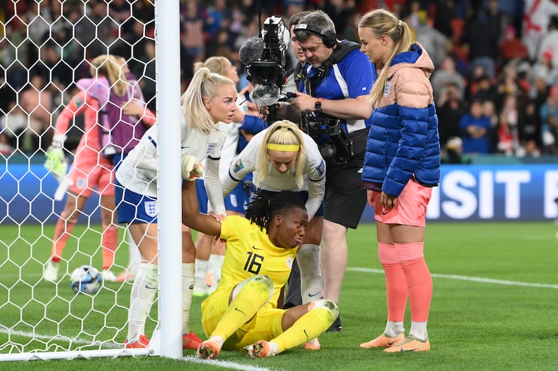Nigeria goalkeeper Chiamaka Nnadozie is consoled by England players after the shoot-out. Getty 