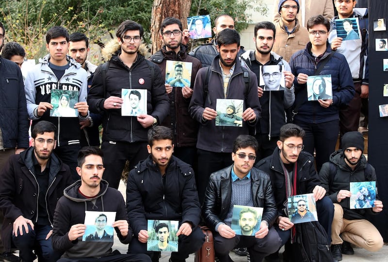 epa08127246 Iranian students hold pictures of victims of Ukraine airplane during a memorial ceremony for passengers of Ukraine airplane, at the Tehran university in Tehran, Iran, 14 January 2020. Media reported that some protestors were arrested following protests in Iran in solidarity with victims of the Ukraine plane shooting down. Iranian President Hassan Rouhani said on 14 January that the accidental shooting down of a Ukrainian passenger plane last week was an unforgivable error and that all those responsible will be punished.  EPA/ABEDIN TAHERKENAREH