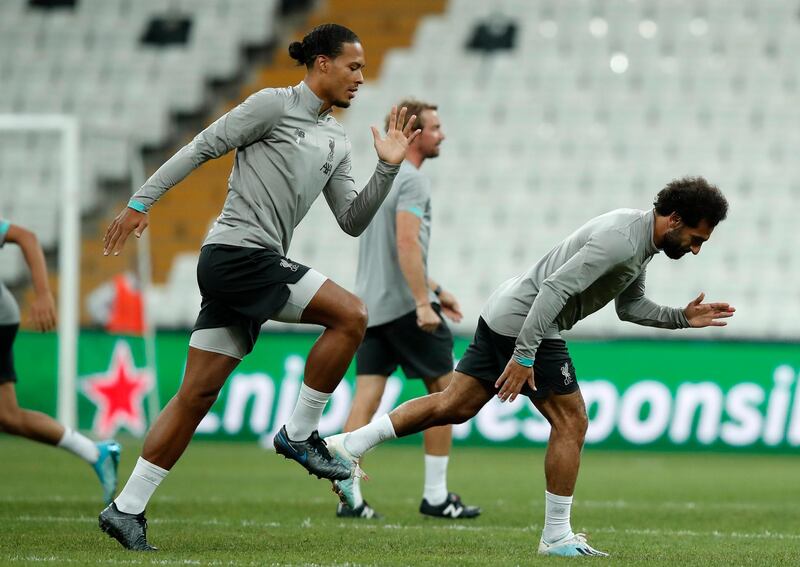 Van Dijk and Salah run during a training session. AP Photo