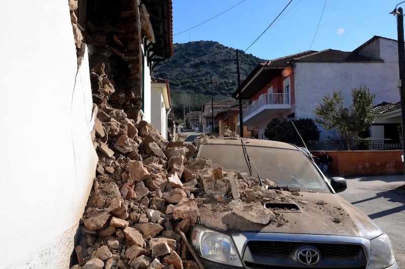 A parked car is covered in debris in Damasi. EPA
