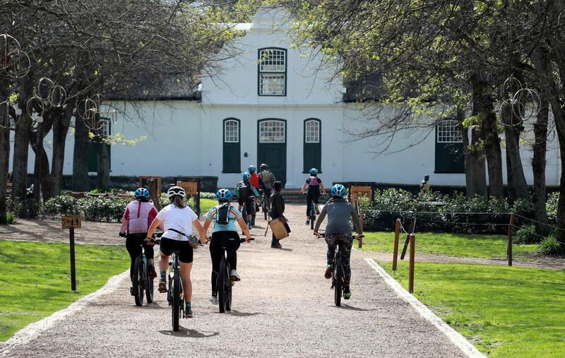 Local tourists are seen during an adventure e-bike tour, run by tour operator Raino Bolz, on the Boschendal Estate near, Cape Town South Africa, Friday, Sept. 4, 2020. Africa's tourism sector is struggling to cope with the drop in international travel caused by the COVID-19 pandemic. The World Travel and Tourism Council estimates the drop in travel caused by the COVID-19 pandemic will see Africa lose between $53 billion and $120 billion in contributions to its GDP in 2020. (AP Photo/Nardus Engelbrecht)