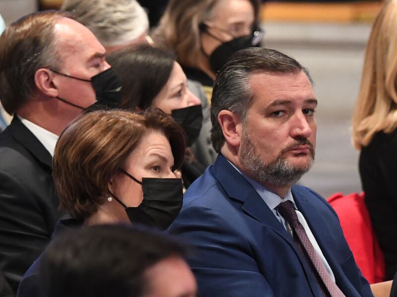 US senators Ted Cruz and Amy Klobuchar attend the funeral service. Mr Cruz was the only attendee not wearing a mask. AFP