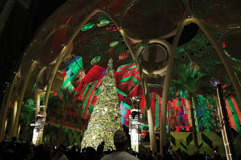 Visitors view the giant Christmas tree. Pawan Singh / The National