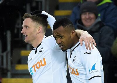 Soccer Football - Premier League - Swansea City vs West Ham United - Liberty Stadium, Swansea, Britain - March 3, 2018   Swansea City's Andy King celebrates scoring their third goal with Jordon Ayew      REUTERS/Rebecca Naden    EDITORIAL USE ONLY. No use with unauthorized audio, video, data, fixture lists, club/league logos or "live" services. Online in-match use limited to 75 images, no video emulation. No use in betting, games or single club/league/player publications.  Please contact your account representative for further details.