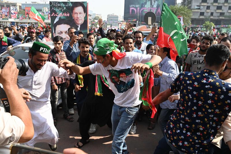 Tehreek-e-Insaf supporters in buoyant mood in Lahore, before the start of the 400-kilometre march. AFP
