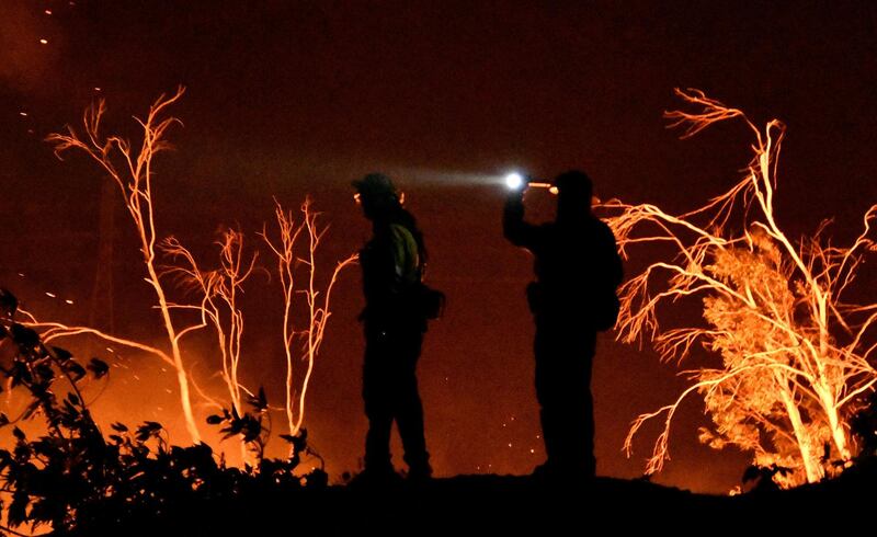 Firefighters keep watch on the Thomas wildfire in the hills and canyons outside Montecito, California, US. Gene Blevins / Reuters