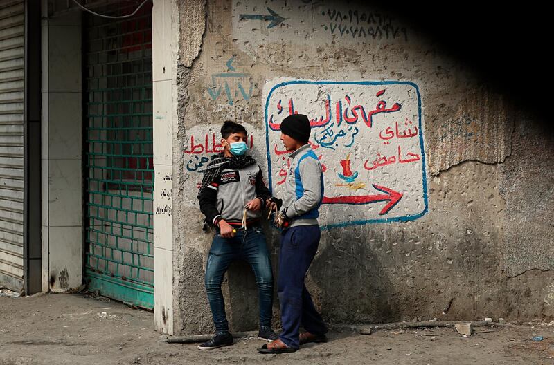 Protesters prepare to use slingshots to fire a stone at security forces during clashes in Baghdad, Iraq. AP Photo