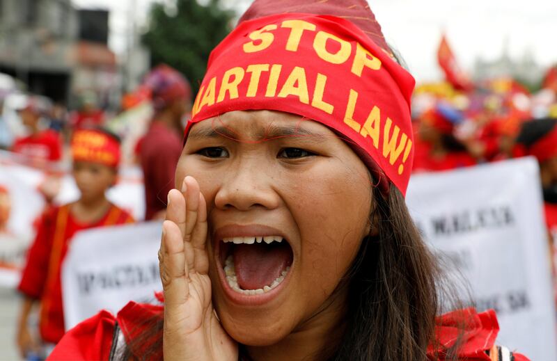 A protester chants anti-government slogans during a march towards the Philippine Congress ahead of president Rodrigo Duterte's State of the Nation address. Erik De Castro / Reuters