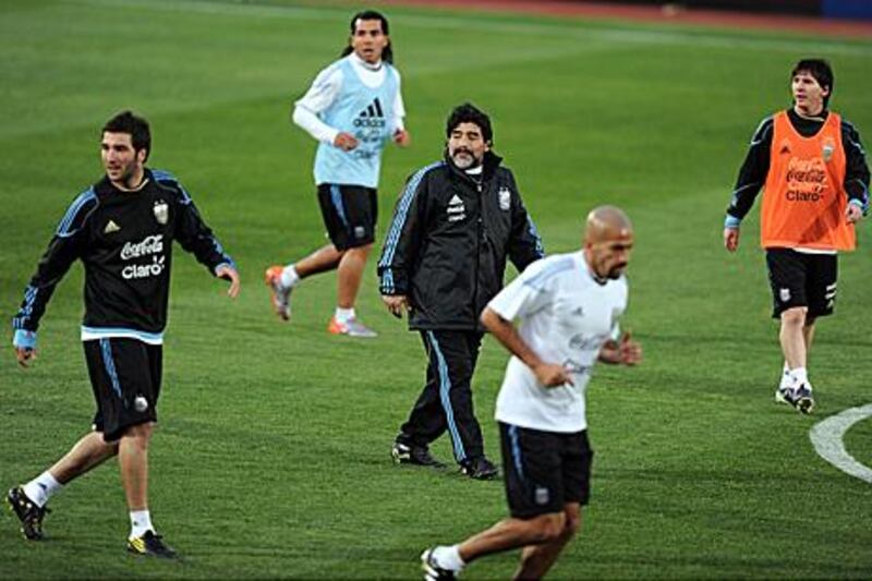 Diego Maradona, centre, has worked with some of the world's best players during his days as coach of the Argentina national team, including Lionel Messi, above right, and Carlos Tevez, above left. Will his mere presence overbear the players at Al Wasl next season?
