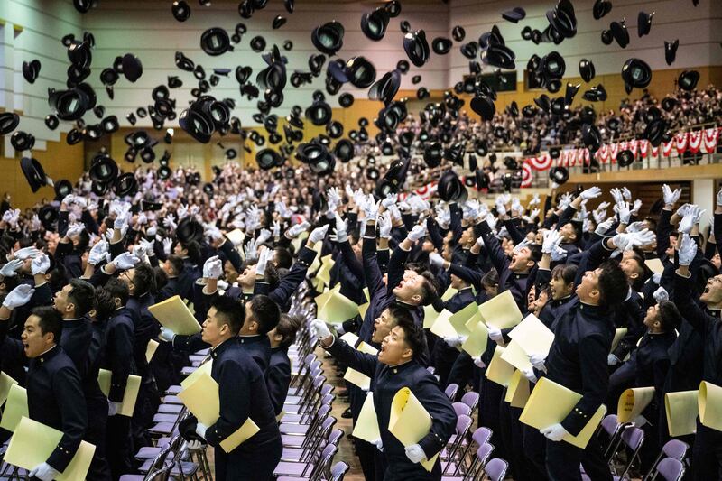 Students of the National Defence Academy of Japan toss their caps in the air during their graduation ceremony in Yokosuka, Kanagawa prefecture. AFP
