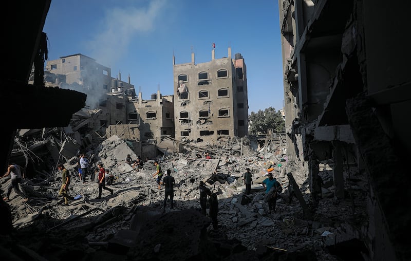 Residents search survivors among the rubble following Israeli strikes on Jabalia, northern Gaza. EPA