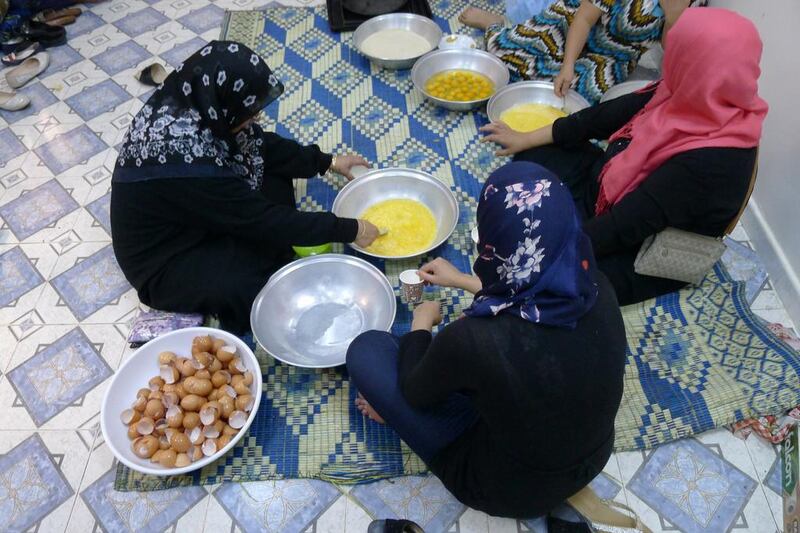 The women preparing eggs to make ghraiba, which are a type of traditional meat-filled dumpling. Tom Wescott for The National.