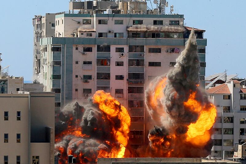 FILE PHOTO: An explosion is near a tower housing AP,  Al Jazeera offices during Israeli missile strikes in Gaza city, May 15. Reuters